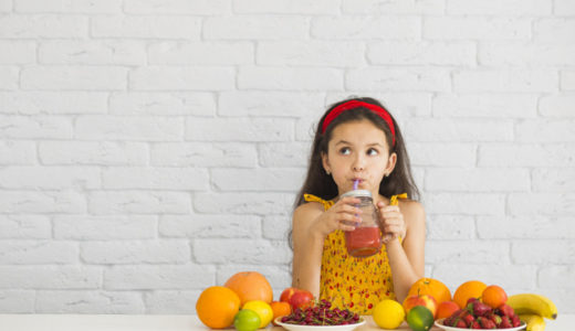girl-drinking-strawberry-smoothies-with-colorful-fruits-desk girl-drinking-strawberry-smoothies-with-colorful-fruits-desk